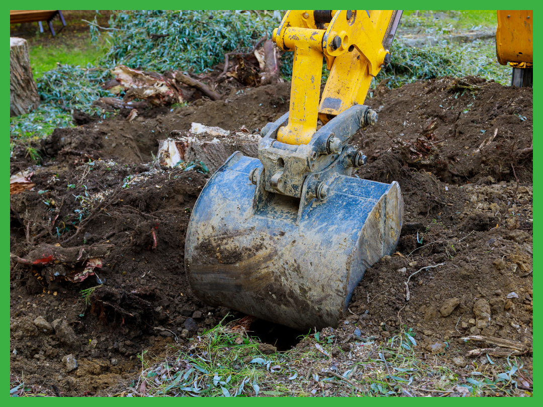 Wichita Falls Tree Service performing professional stump removal with a backhoe, digging out the tree stump and its extensive roots, leaving the area ready for new landscaping.